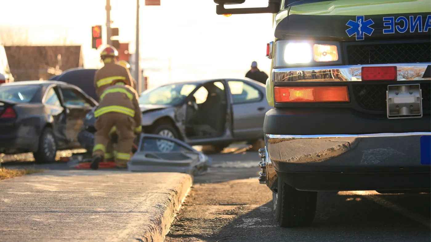 First responders working a car accident scene at a California intersection